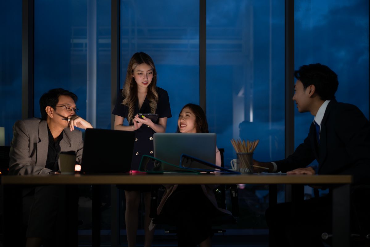 employees and executives in an office at night building scalable systems