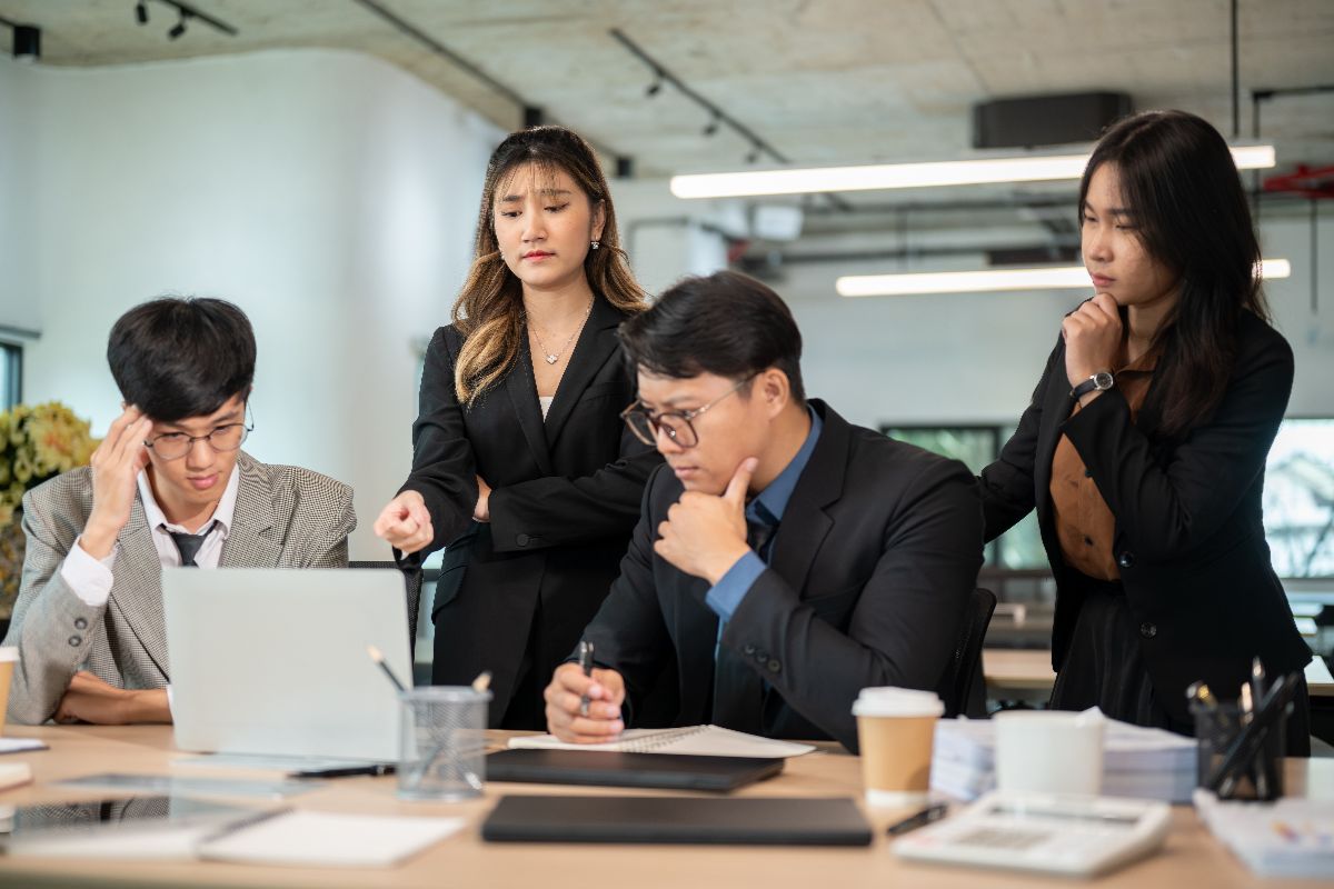 Professionals analyzing leadership challenges and executive search needs in a growing company