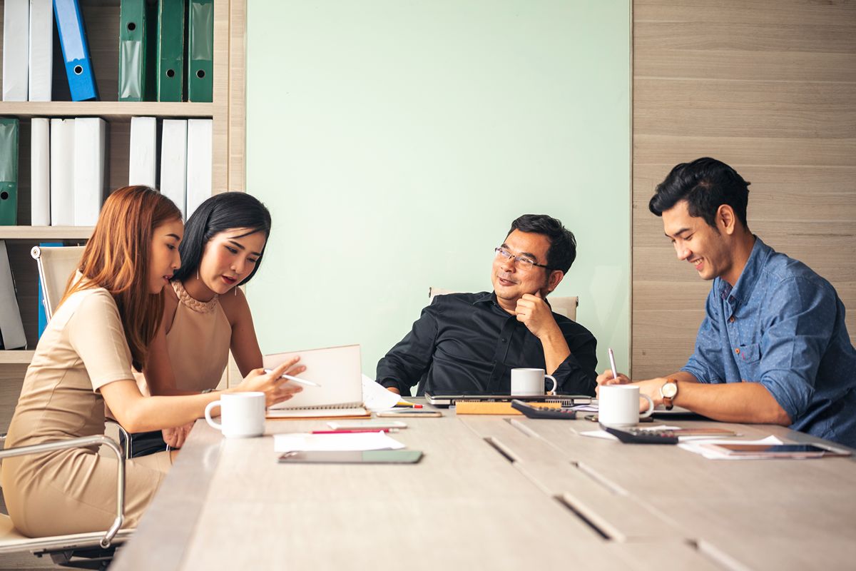 Business leaders discussing executive compensation and salary benchmarking in a meeting
