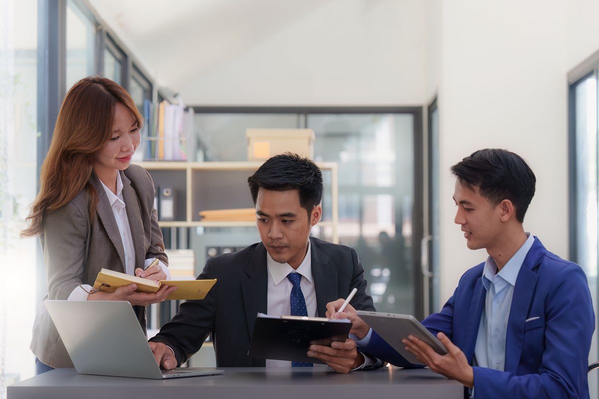Executive hiring team reviewing compensation data and salary benchmarking insights in an office