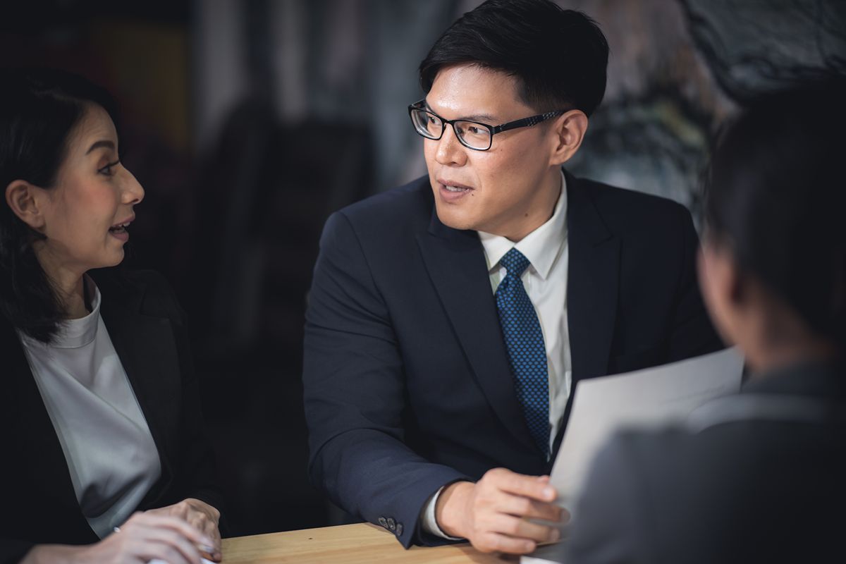 Business professionals evaluating an executive candidate through structured assessment and discussion