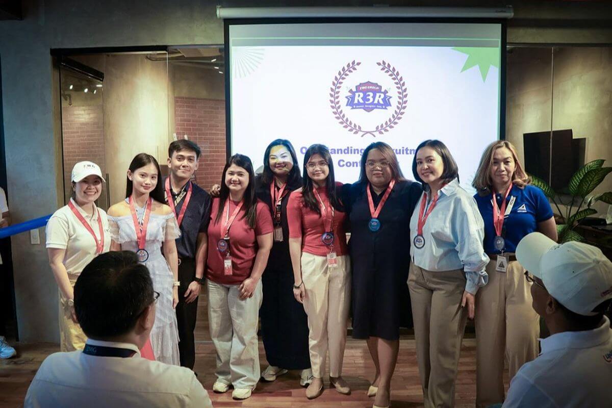 employees wearing medals and posing together during a company recognition event