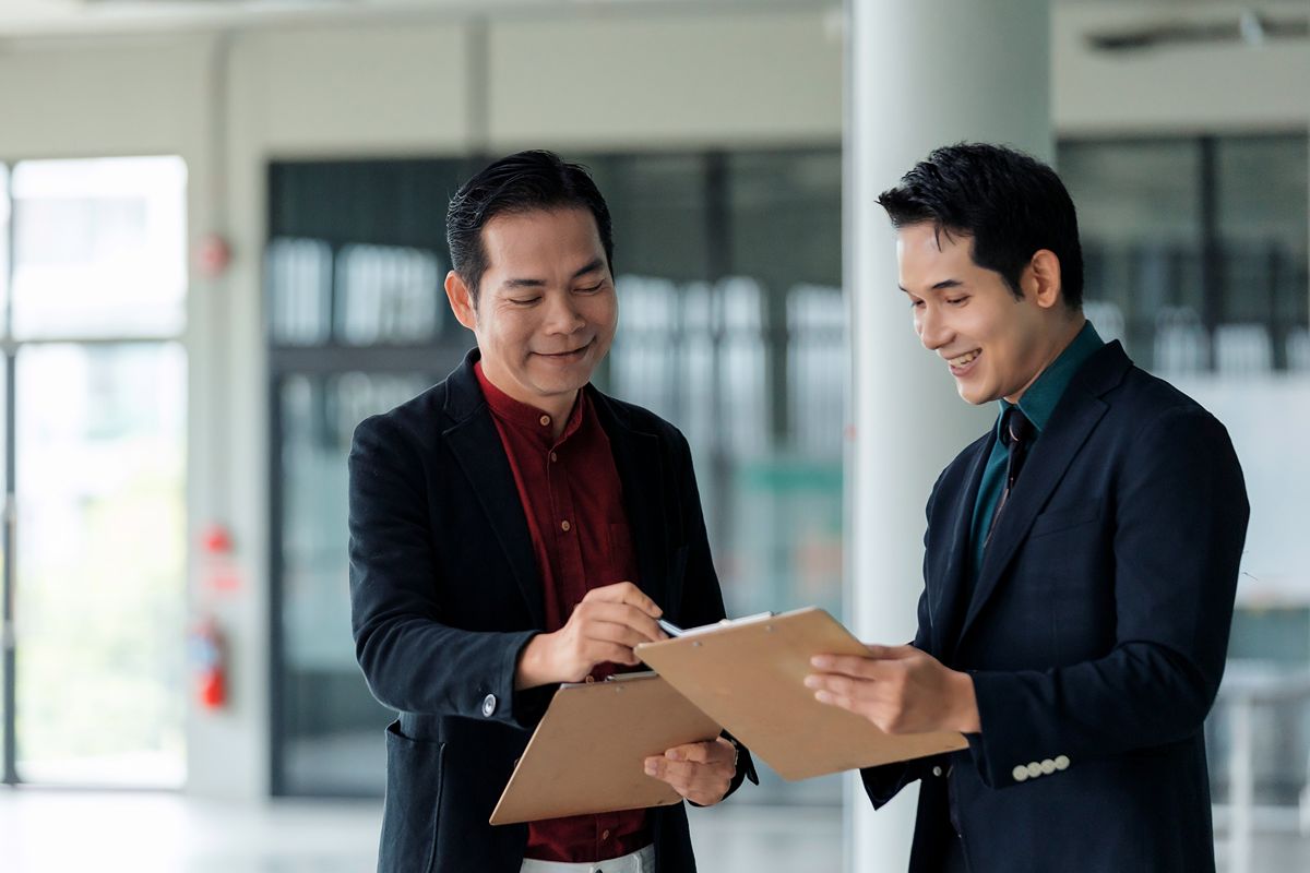 Business team reviewing leadership search details and market intelligence during a confidential meeting