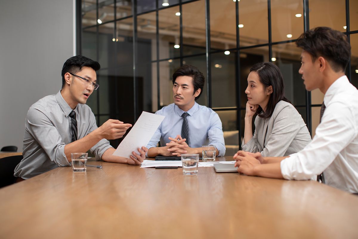 Executives discussing leadership transition planning and risk management in a private office setting