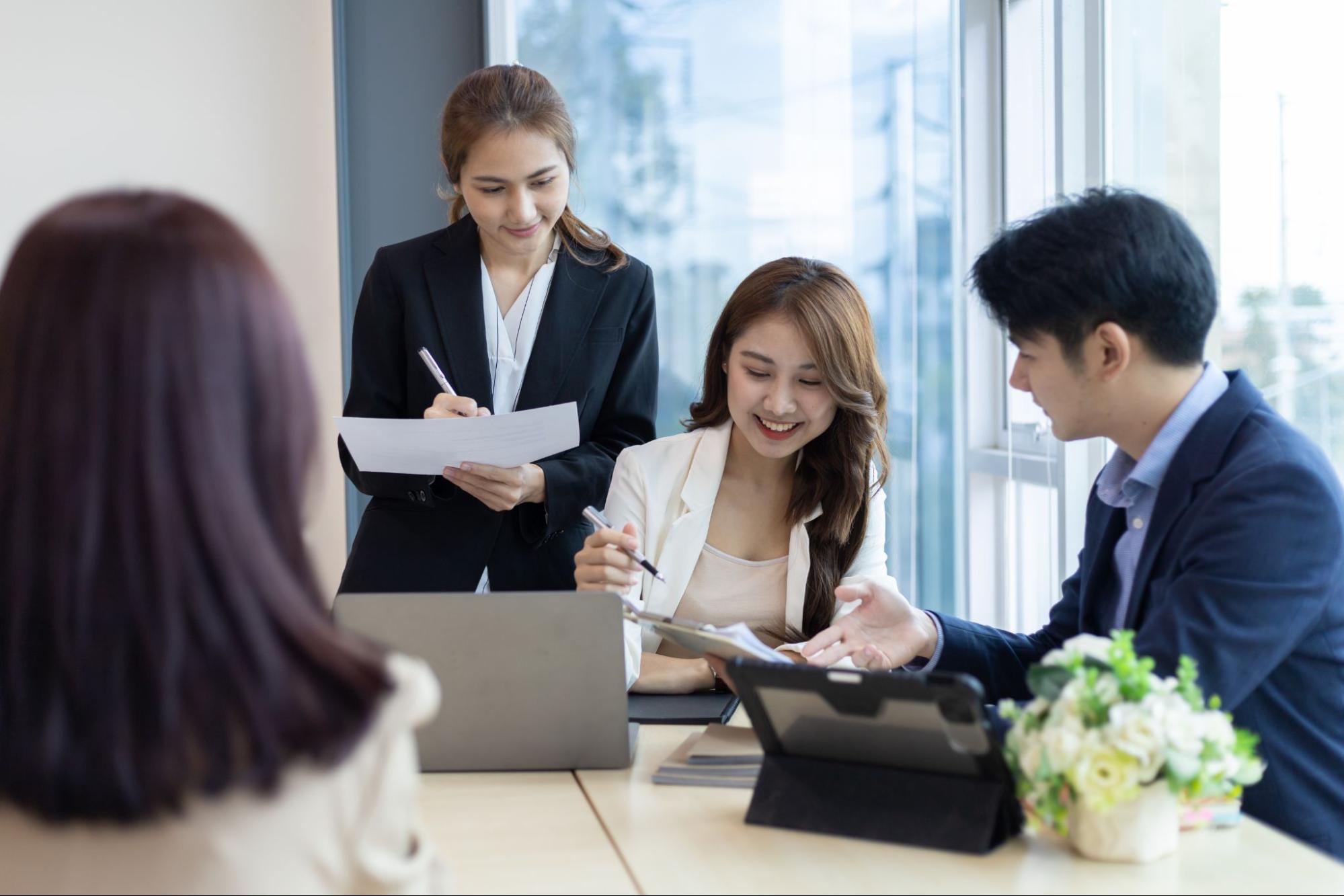 Business team reviewing leadership search details and market intelligence during a confidential meeting