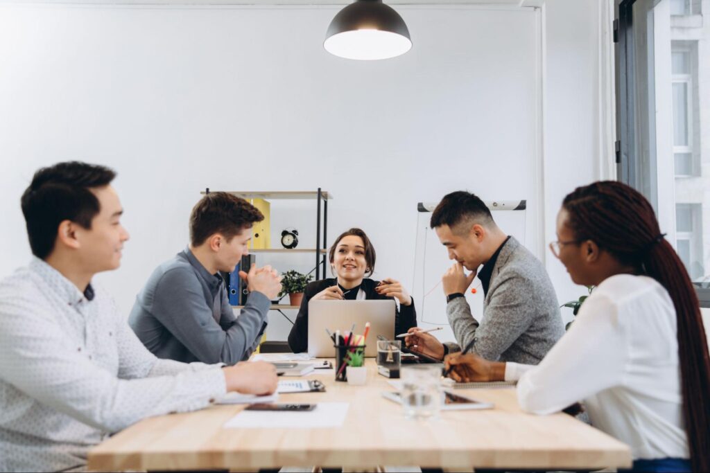 Executive search consultant discussing confidential leadership hiring with professionals in a private meeting