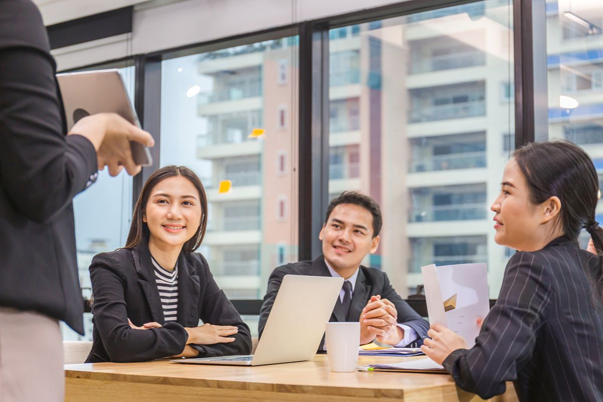 Professionals reviewing leadership messaging and employer branding during an executive hiring discussion