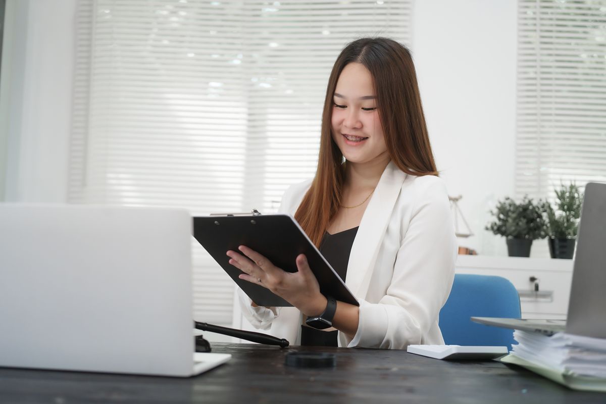 Business professional reviewing information on a tablet while assessing modern leadership competencies and digital skills