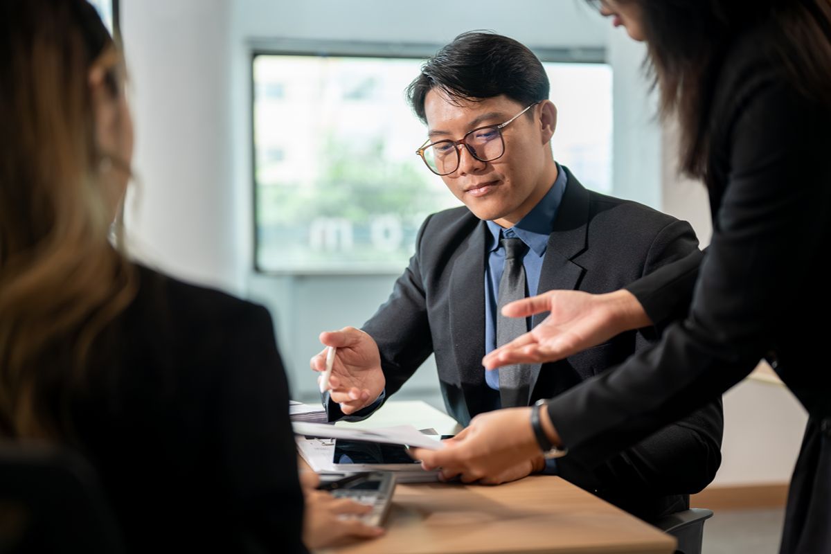 Business professionals reviewing executive recruitment options and comparing retained search with contingency search models