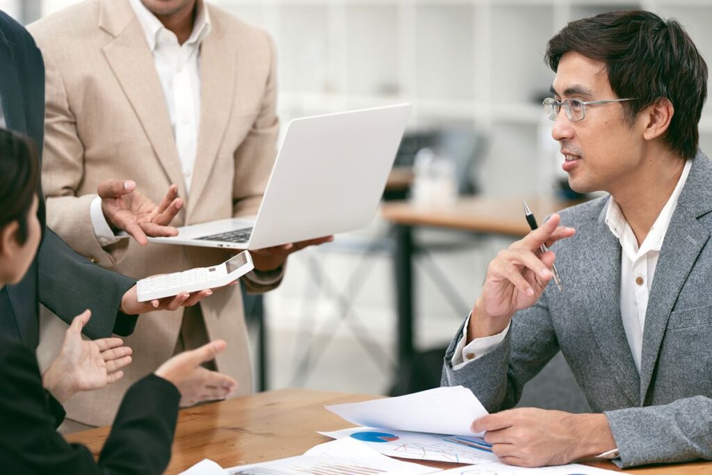 Business professionals discussing retained executive search strategies and leadership recruitment during a corporate meeting